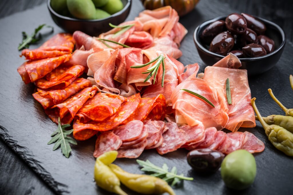 Charcuterie board with prosciutto ham, salami, olives and tapas